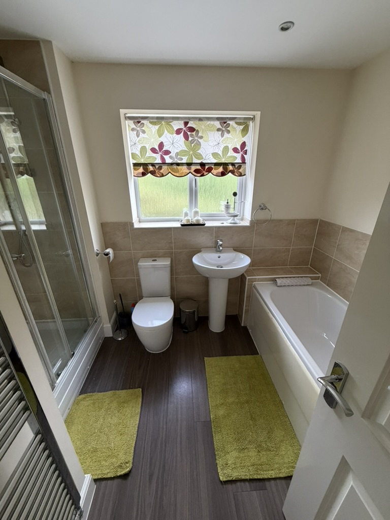 Family bathroom with bath and separate shower at the Kings Cliffe property