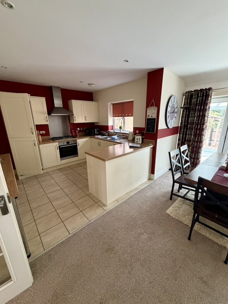 Open-plan fitted kitchen and dining area in the Kings Cliffe house